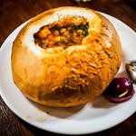Bean soup with smoked bacon served in bread bowl(Caru' cu bere)