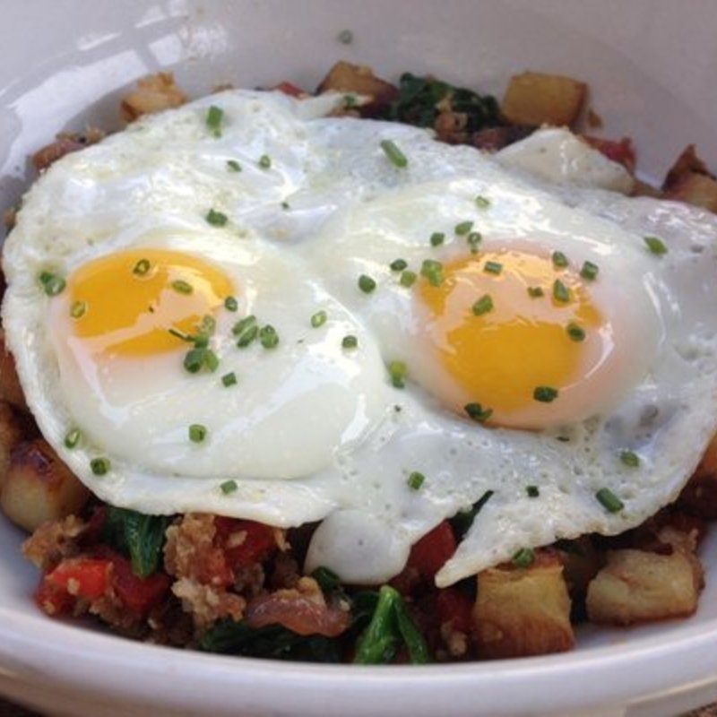 Pork belly hash, roasted peppers and onions, russet potatoes, two fried eggs, spinach (The Sycamore Kitchen)