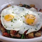 Pork belly hash, roasted peppers and onions, russet potatoes, two fried eggs, spinach (The Sycamore Kitchen)