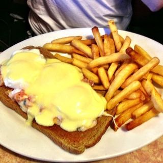 Eggs Benedict over bruschetta and whole wheat toast and a side of fries(Brownstone Diner )