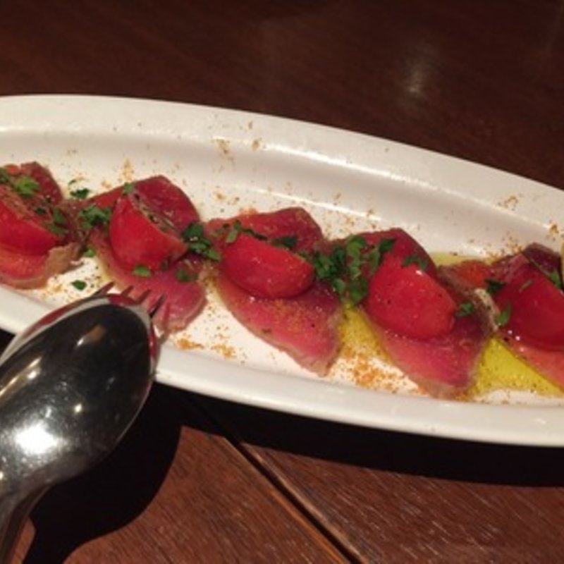 自家製マグロの生ハムと高知産フルーツトマトのカルパッチョ仕立て(ピッツエリア・バッジオ （PIZZERIA BAGGIO）)